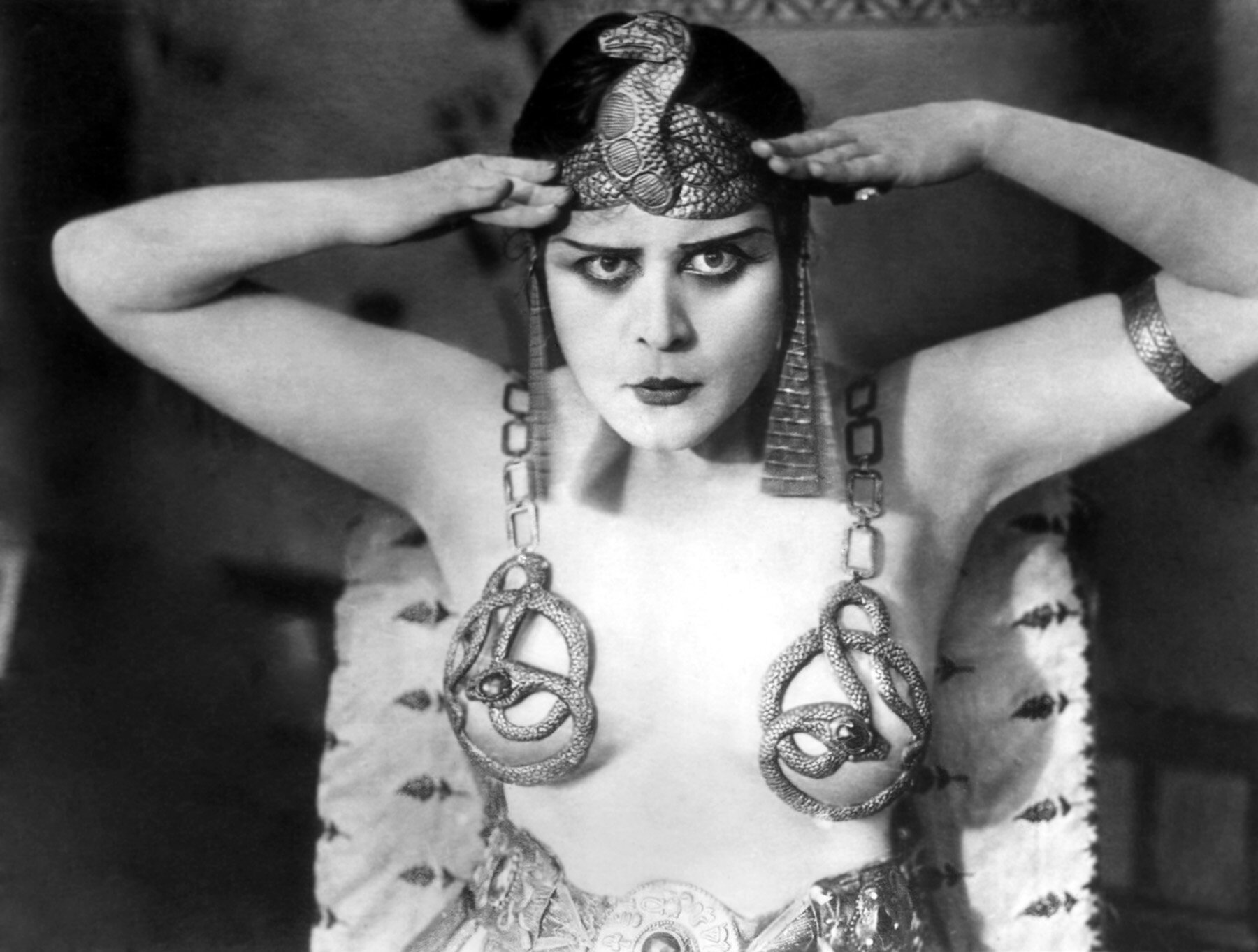 1917: Promotional portrait of American actor Theda Bara (1885 - 1955) wearing an Egyptian headdress and breast plates with a snake design for director J Gordon Edwards' film, 'Cleopatra'.